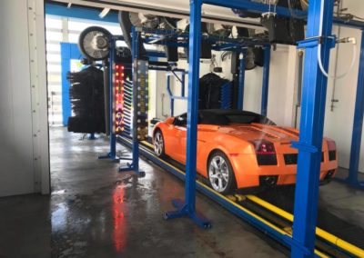 Larry's Car Wash orange sports car going through tunnel