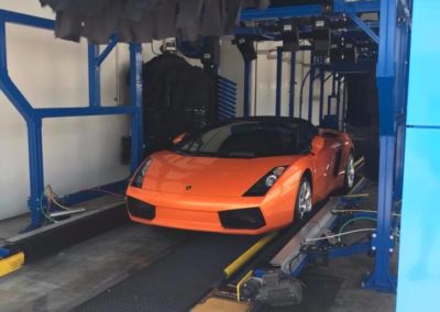 Exotic car exiting car wash tunnel at Larry's Car Wash