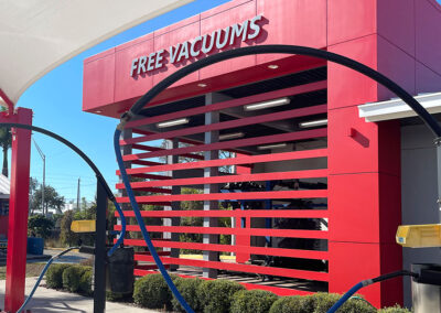 Car wash tunnel entrance with Free Vacuums sign